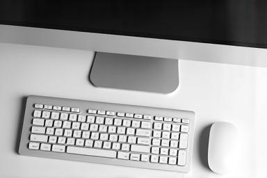 A clean desk with a computer mouse and keyboard.